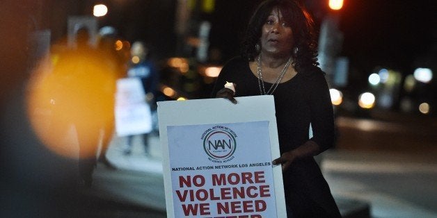 Members of a coalition of local activists, church groups and community leaders try to promote peace amongst rival street gangs in an area known as ``death alley,'' where the highest rates of homicide in the city occur, in Los Angeles, California on August 7, 2015. Gang violence has increased in Los Angeles in 2015 with reports of two gangs allegedly entering into a competition to see which one can kill 100 people in the next 100 days. AFP PHOTO / MARK RALSTON (Photo credit should read MARK RALSTON/AFP/Getty Images)