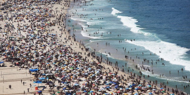 RIO DE JANEIRO, BRAZIL - AUGUST 16: People gather on the beach during a protest calling for the impeachment of President Dilma Rousseff along Copacabana beach on August 16, 2015 in Rio de Janeiro, Brazil. A massive corruption scandal at Brazil's state-owned oil company Petrobras has rocked the nation which is now in the midst of a hard-hitting recession ahead of the Rio 2016 Olympic Games. Rousseff's approval rating has dropped below ten percent. (Photo by Mario Tama/Getty Images)