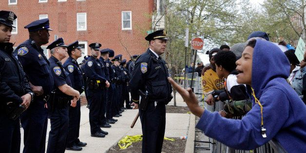 Members of the Baltimore Police Department stand guard outside the department's Western District police station during a protest for Freddie Gray, Thursday, April 23, 2015, in Baltimore. Gray died from spinal injuries about a week after he was arrested and transported in a police van. (AP Photo/Patrick Semansky)