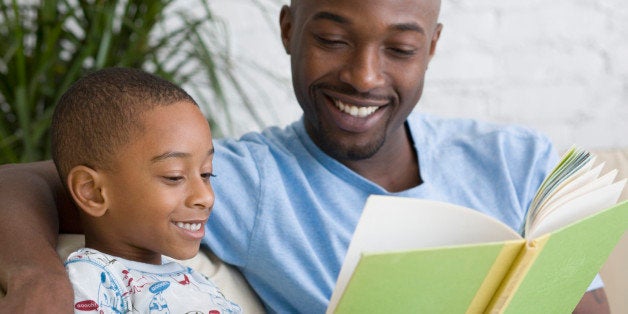 African father and son reading