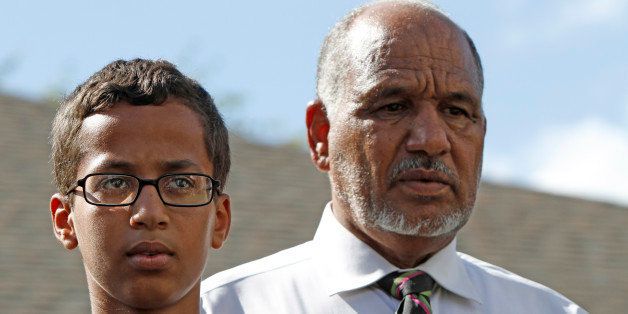 IRVING, TX - SEPTEMBER 16: 14-year-old Ahmed Ahmed Mohamed stands with his father Mohamed Elhassan Mohamed during a news conference on September 16, 2015 in Irving, Texas. Mohammed was detained after a high school teacher falsely concluded that a homemade clock he brought to class might be a bomb. The news converence, held outside the Mohammed family home, was hosted by the North Texas Chapter of the Council on American-Islamic Relations. (Photo by Ben Torres/Getty Images)