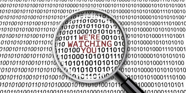 A magnifying glass on binary codes with the words âWeâre watching youâ in focus