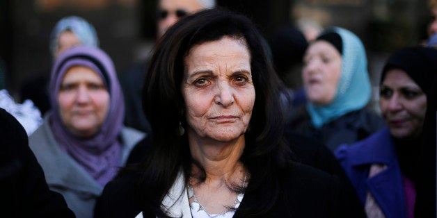 Rasmea Odeh listens to supporters after leaving federal court in Detroit Thursday, March 12, 2015. A judge sentenced the Chicago activist to 18 months in federal prison Thursday for failing to disclose her convictions for bombings in Israel when she applied to be a U.S. citizen. Odeh, 67, also was stripped of her citizenship and eventually will be deported. But she will remain free while she appeals the case. (AP Photo/Paul Sancya)