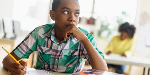 Black student thinking in classroom