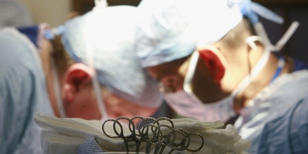 BIRMINGHAM, UNITED KINGDOM - JUNE 09: The kidney of Tracey Playfair is implanted in the groin area of her sister by Consultant Surgeon Andrew Ready and his team during a live donor kidney transplant at The Queen Elizabeth Hospital Birmingham on June 9, 2006, in Birmingham, England. Kidney failure patient Carol Playfair was given the chance of life when her sister Tracey Playfair offered one of her own perfect kidneys to help save the life of Carol. The operation at The QE Hospital, part of The University Hospital's Trust was one of 1500 live donor transplants carried out in the United Kingdon every year. Despite the introduction of Donor Cards, there are still too few kidneys available to help all those who require a transplant, thereby producing a waiting list and the only chance of survival is by live donor. (Photo by Christopher Furlong/Getty Images)