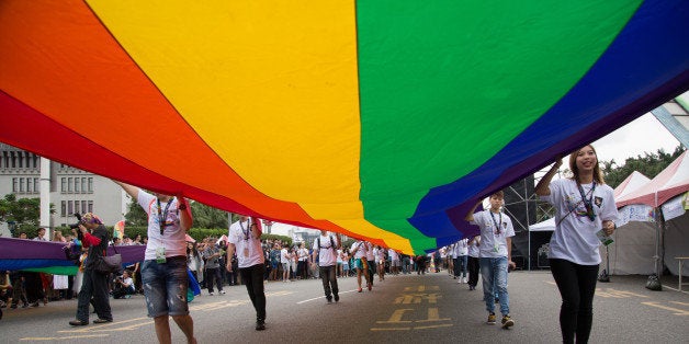 TAIPEI, TAIWAN - 2015/10/31: The rainbow flag, a symbol of gay rights, leads off the annual LGBT pride march. Upwards of 60 0