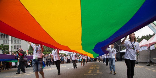 TAIPEI, TAIWAN - 2015/10/31: The rainbow flag, a symbol of gay rights, leads off the annual LGBT pride march. Upwards of 60 000 people took to the streets of Taipei for the annual Pride march, the largest such event in Asia. Taiwan is often said to be the likeliest Asian nation to legalize gay marriage. (Photo by Craig Ferguson/LightRocket via Getty Images)