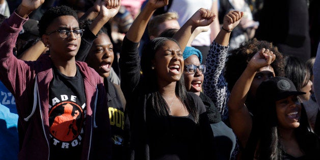 FILE - In this Nov. 9, 2015, file photo, students cheer while listening to members of the black student protest group Concern