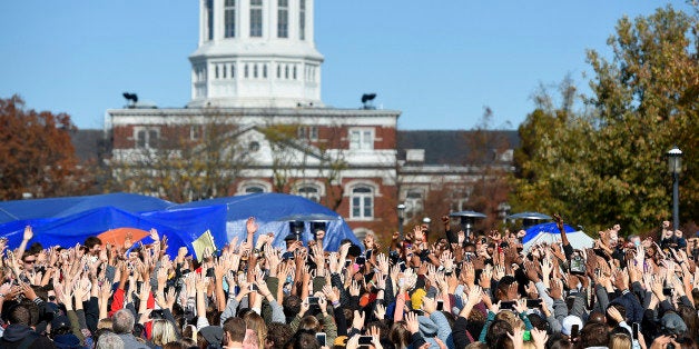 Student protesters on the campus of the University of Missouri in Columbia react to news of the resignation of University of Missouri system President Tim Wolfe on Monday, Nov. 9, 2015. Wolfe resigned under pressure from student protesters who claimed the president had not done enough to address recent racially-motivated incidents on the campus. (David Eulitt/Kansas City Star/TNS via Getty Images)