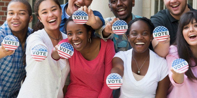 Students holding buttons at voter registration