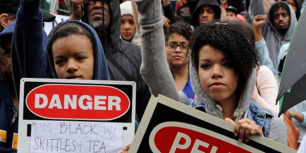 WASHINGTON, DC - MARCH 24: Zoe Guy (L) 15-years-old and her sister Tori Guy (R) 19-years-old came to Freedom Plaza to show their support for the slain Florida teen Trayvon Martin on March 24, 2012. Tori is with the Black Student Union of George Washington University. Attendees to the rally were asked to wear hoods and carry Skittles. (Photo by Tracy A. Woodward/The Washington Post via Getty Images)