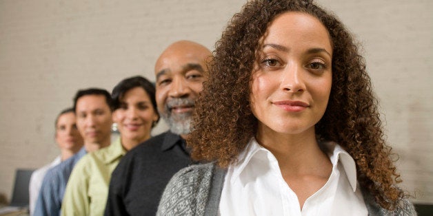 Group of business people standing in row, portrait