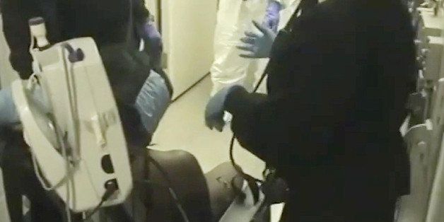 In this Feb. 3, 2015 frame from video provided by the Fairfax County, Va., Sheriff, deputies work to restrain Natasha McKenna during a cell transfer, in Fairfax, Va. The video was released Thursday, Sept. 10, two days after prosecutors said they would not bring criminal charges, shows a prolonged struggle with the mentally ill inmate who died after being shocked with a stun gun. (Fairfax County Sheriff via AP)