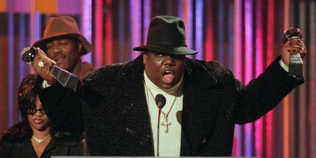 ** FILE ** Notorious B.I.G., who won rap artist and rap single of the year, clutches his awards at the podium during the annu