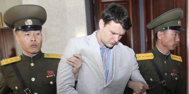 American student Otto Warmbier, center, is escorted at the Supreme Court in Pyongyang, North Korea, Wednesday, March 16, 2016. North Korea's highest court sentenced Warmbier, a 21-year-old University of Virginia undergraduate student, from Wyoming, Ohio, to 15 years in prison with hard labor on Wednesday for subversion. He allegedly attempted to steal a propaganda banner from a restricted area of his hotel at the request of an acquaintance who wanted to hang it in her church. (AP Photo/Jon Chol Jin)