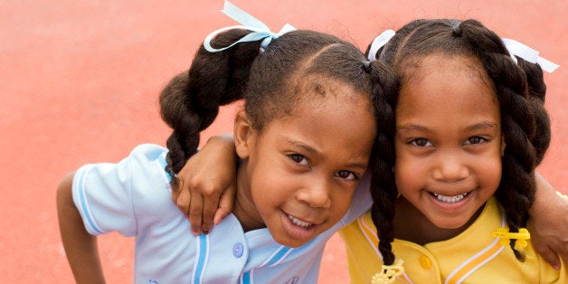 Twin girls arm-in-arm