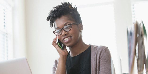 Black businesswoman talking on cell phone in office