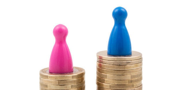 Pink and blue figures on different coin stacks. Concept for gender pay gap.