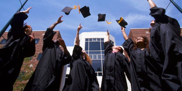 Graduates throwing their caps into the air