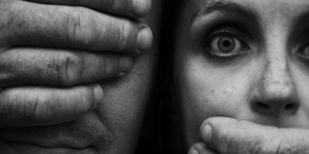 Hands Covering Man's Eye and Startled Woman's Mouth