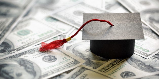 Graduation mortar board cap on one hundred dollar bills concept for the cost of a college and university education