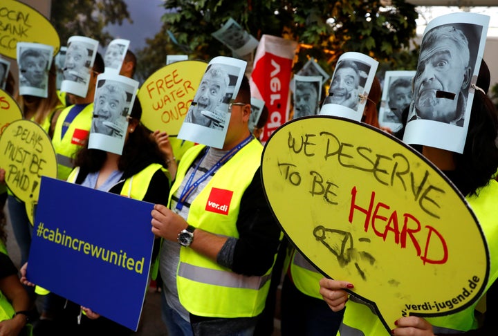 Employees stood outside Frankfury airport with signs that explained their grievances 