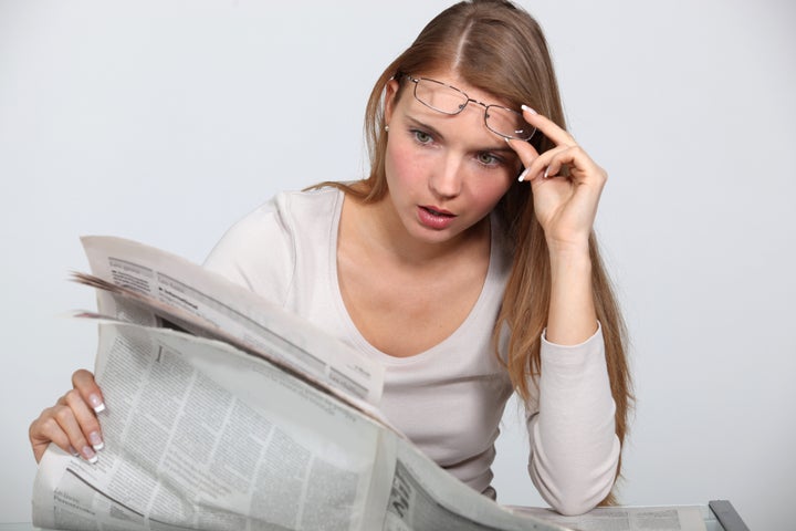 woman shocked by newspaper...