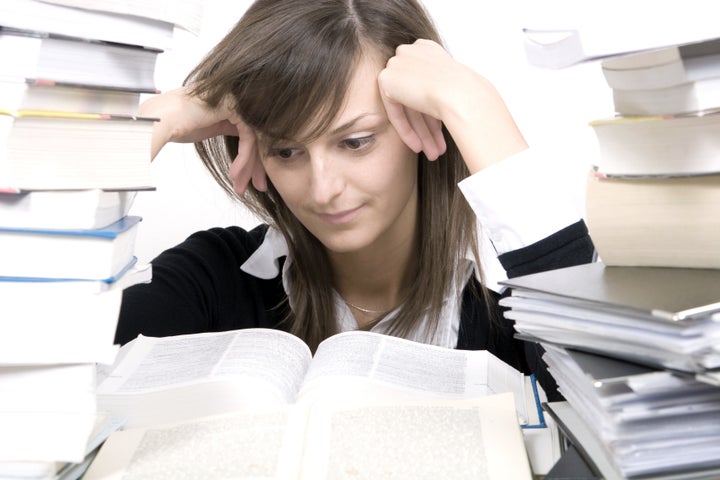 woman and a pile of books