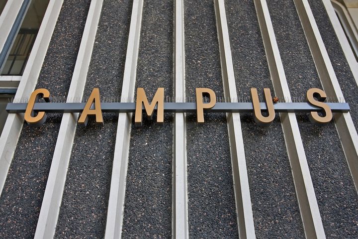 campus sign on the steel rails...