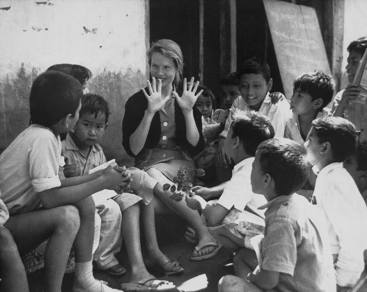 Female Peace Corps volunteer teaching children, Nepal