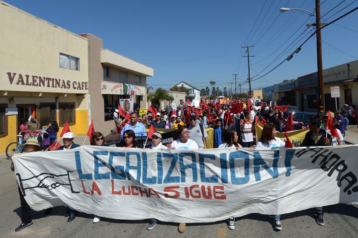 Hundreds of people march through the streets of Oxnard, California, as they participate in a march for immigration reform and to honor the legacy of Cesar E. Chavez, founder of the United Farm Workers of America, on March 24, 2013. AFP PHOTO/JOE KLAMAR (Photo credit should read JOE KLAMAR/AFP/Getty Images)