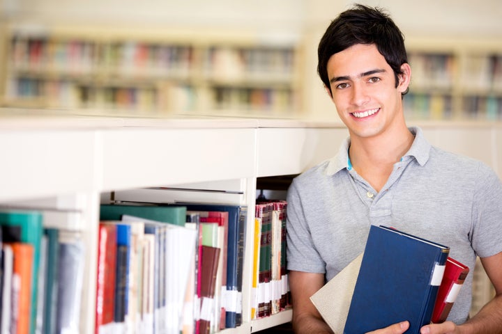 happy male student holding...