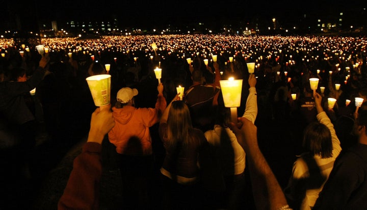 BLACKSBURG, VA - APRIL 16: Mourners participate in a candlelight vigil on Virginia Tech's Day of Remembrance honoring the 32 people killed by Cho Seung-Hui April 16, 2008 in Blacksburg, Virginia. Today is the one-year anniversary of the worst school shooting in US history. (Photo by Mario Tama/Getty Images)