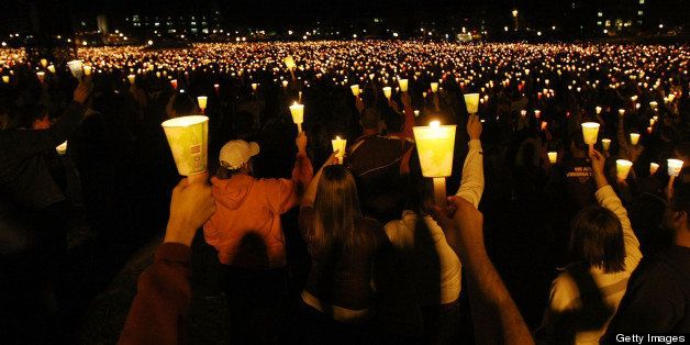 BLACKSBURG, VA - APRIL 16: Mourners participate in a candlelight vigil on Virginia Tech's Day of Remembrance honoring the 32 people killed by Cho Seung-Hui April 16, 2008 in Blacksburg, Virginia. Today is the one-year anniversary of the worst school shooting in US history. (Photo by Mario Tama/Getty Images)