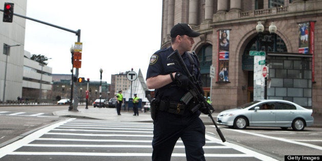 BOSTON, MA - APRIL 19: A swat team member scouts the perimeter of South Station on April 19, 2013 in Boston, Massachusetts.
