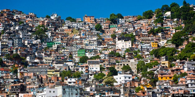 Favela Rocinha, Rio de Janeiro, Brazil. Rocinha is the largest and most well-known favela in Brazil. Built on a steep hillside overlooking the city, it's only a kilometer from the beach. Most houses are made from concrete and brick. Some buildings are four stories high and almost all houses have basic sanitation, plumbing, and electricity. Rocinha has a developed infrastructure and hundreds of businesses, including banks and drugstores, and has bus lines, cable television, and telephone service.