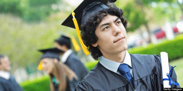 Proud Asian student holding diploma after graduating from college