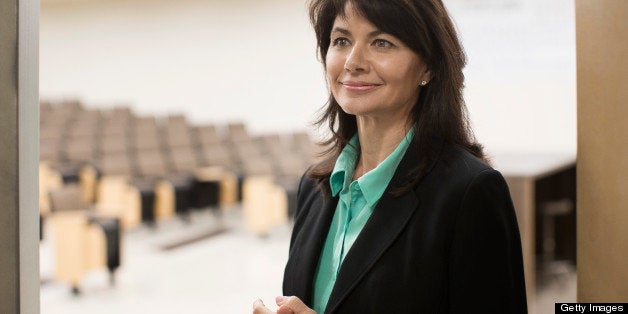 Caucasian teacher in empty classroom