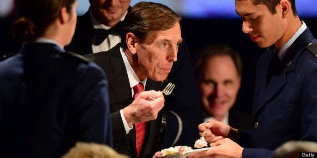 Former CIA director David Petraeus has a piece of the cake he cut prior to speaking at a University of Southern California event honoring the military on March 26, 2013 in Los Angeles, California. In the first public appearance since stepping down last November as head of the CIA after admitting to an affair, Petraeus said he regretted and apologized for the circumstances that led to his resignation. AFP PHOTO / Frederic J. BROWN (Photo credit should read FREDERIC J. BROWN/AFP/Getty Images)