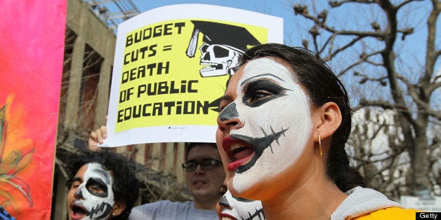 BERKELEY, CA - MARCH 04: Students at UC Berkeley carry signs as they march through campus during a national day of action ag