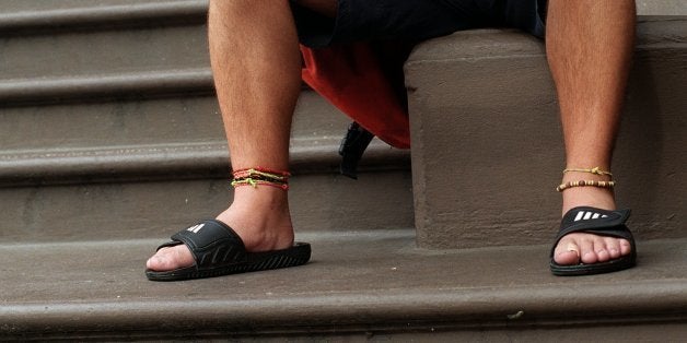 BOSTON - OCTOBER 27: Emerson College student Brian Flanagan sits on school steps on Beacon Street reading a newspaper, wearing shorts and sandals on a warm day in October. (Photo by David L Ryan/The Boston Globe via Getty Images)