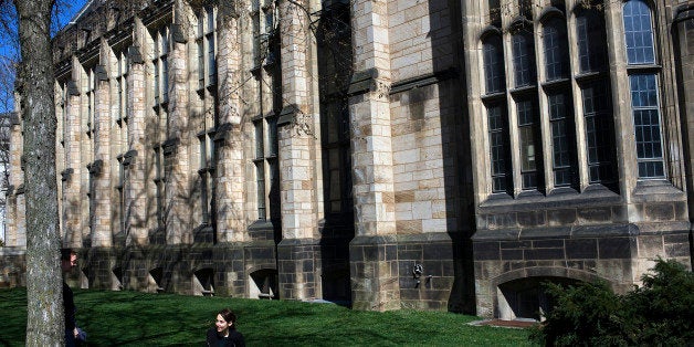 NEW HAVEN, CT - APRIL 15: A woman sits on the grass on the campus of Yale University April 15, 2008 in New Haven, Connecticut. New Haven boasts many educational and cultural offerings that attract visitors to the city. (Photo by Christopher Capozziello/Getty Images)