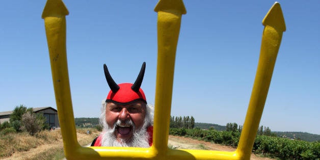 Marseille, FRANCE: TO GO WITH AFP STORY : 'EL DIABLO'S NAME IS DIETER SENFT' - German fan Dieter Senft, known as El Diablo, poses with his devil costume in Saint-Maximin la-Sainte-Baume near Marseille as he waits for the riders during the tenth stage of the 94th Tour de France cycling race between Tallard and Marseille, 18 July 2007. Born in 1952 near Berlin, Didi Senft was a cyclist amateur and won several trophy in his region. Didi has been following the Tour de France since 1993 and chose to dress as a devil because German sportscasters refer to the last kilometer of a criterium as 'the red devil's lap'. Didi Senft finances his travels by means of a small number of corporate sponsors, and with money from his wife's job and donations from other Tour de France fans. But this year, sponsors were hesitant because of doping problems. He usually sleeps in his car between stages to keep expenditure to a minimum. AFP PHOTO / JOE KLAMAR (Photo credit should read JOE KLAMAR/AFP/Getty Images)