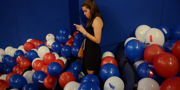 A girl uses her mobile phone at the Republican National Convention (RNC) in Tampa, Florida, U.S., on Thursday, Aug. 30, 2012. Republican presidential nominee Mitt Romney, a wealthy former business executive who served as Massachusetts governor and as a bishop in the Mormon church, is under pressure to show undecided voters more personality and emotion in his convention speech tonight, even as fiscal conservatives in his own party say he must more clearly define his plans for reining in the deficit and improving the economy. Photographer: Daniel Acker/Bloomberg via Getty Images