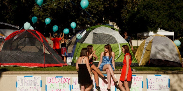 Carly Mee, a student at Occidental College, center, talks with other students during the Oxy Sexual Assault Coalition (OSAC) sexual assault awareness night campout at the college campus in Los Angeles, California, U.S., on Friday, April 19, 2013. A group of Occidental students and alumni filed a Title IX complaint with the Education Department on April 18 saying the school doesnt meet federal standards for preventing and responding to rapes and other sexual assaults on campus. Photographer: Patrick Fallon/Bloomberg via Getty Images