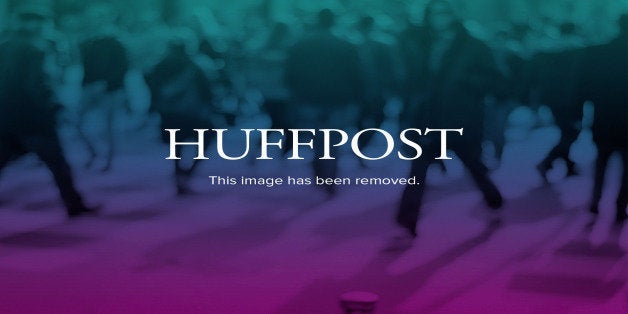 Harvard University President Drew Gilpin Faust clasps hands with a graduate as she walks in the procession at commencement ceremonies in Cambridge, Mass., Thursday, May 30, 2013. (AP Photo/Elise Amendola)