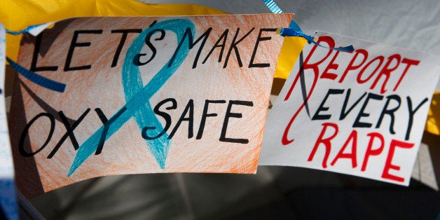 Handmade signs decrying rape decorate tents set up for the Oxy Sexual Assault Coalition (OSAC) sexual assault awareness night campout at Occidental College in Los Angeles, California, U.S., on Friday, April 19, 2013. A group of Occidental students and alumni filed a Title IX complaint with the Education Department on April 18 saying the school doesnt meet federal standards for preventing and responding to rapes and other sexual assaults on campus. Photographer: Patrick Fallon/Bloomberg via Getty Images