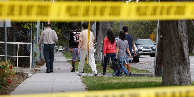 SANTA MONICA, CA - JUNE 08: Students are escorted onto Santa Monica College, which remains closed for a second day as investigators gather evidence from crime scenes, to pick up personal belongings they gad to abandon when a gunman on a mass shooting spree entered the campus, on June 8, 2013 in Santa Monica, California. The shootings occurred in various locations about three miles south of a political fundraiser attended by President Barack Obama but Secret Service officials said the two events were not related and that the president was never in any danger. Four people besides the gunman have died from their wounds and five others wounded, including a woman who is close to death. (Photo by David McNew/Getty Images)