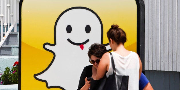 People take pictures in front of the Snapchat Inc. headquarters on the strand at Venice Beach in Los Angeles, California, U.S