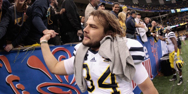 NEW ORLEANS, LA - JANUARY 03: Kicker Brendan Gibbons #34 of the Michigan Wolverines celebrates with fans after Michigan won 23-20 in overtime on Gibbons 37-yard game-winning field goal against the Virginia Tech Hokies during the Allstate Sugar Bowl at Mercedes-Benz Superdome on January 3, 2012 in New Orleans, Louisiana. (Photo by Chris Graythen/Getty Images)